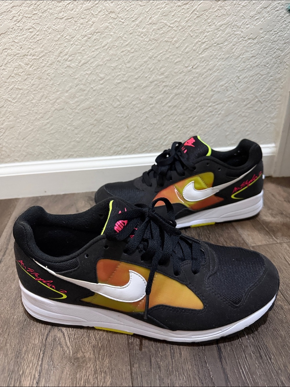 Nike Black Sneakers with White Swoosh and Yellow-Orange Gradient Panels
